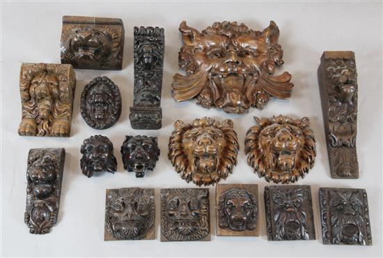 A collection of sixteen 17th / 18th century carved oak lion heads and grotesque masks,